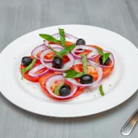 Fresh Tomato Salad · Red onions and olive in olive oil, basil and oregano dressing. Tomate fresco, cebolla y acei...