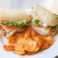 Classic Club · Hills own baked ham, hills own roasted turkey breast, Swiss, bacon, lettuce, tomato, onion a...