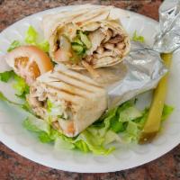 Chicken Shawerma Sandwich · Served in pita bread with garlic sauce, pickles, lettuce, tomatoes, onions and hummus.