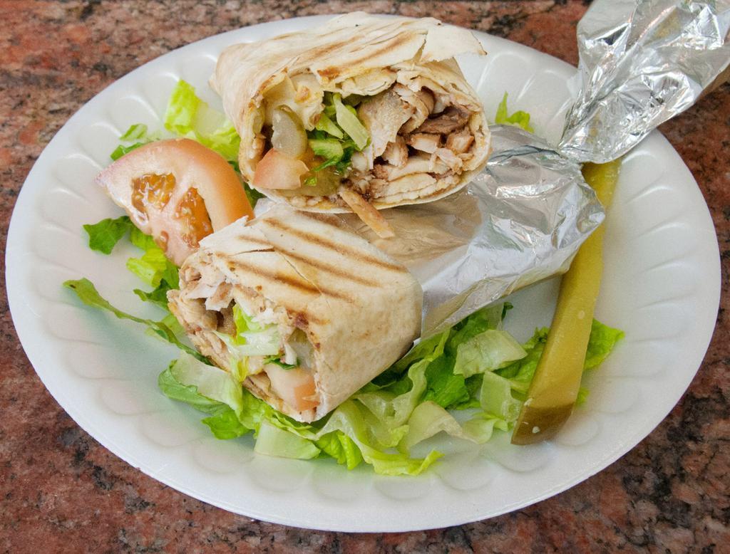 Chicken Shawerma Sandwich · Served in pita bread with garlic sauce, pickles, lettuce, tomatoes, onions and hummus.
