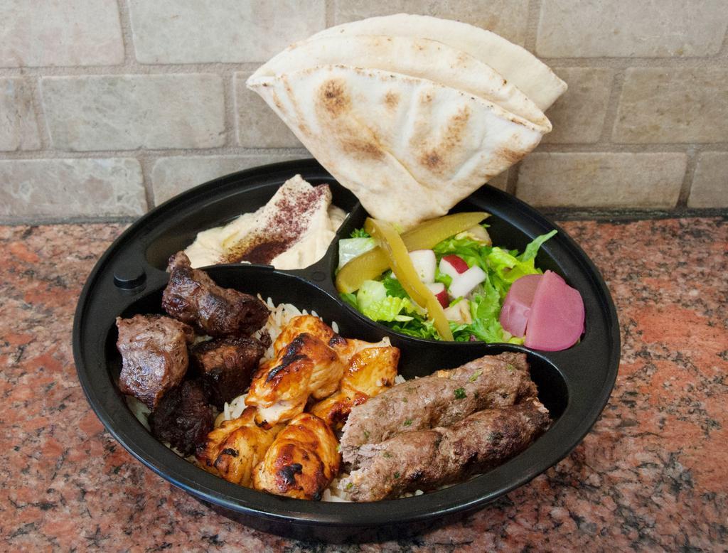 Al Nour Platter · 1Beef kabab,1chicken kabab,1kofta kabab 
Served with rice, salad, hummus, with tahini sauce and pita bread.