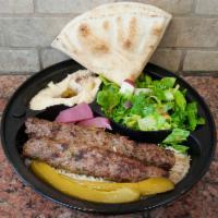Kufta Kebab plate · 2 kofta kabab skewer Served with rice, salad, hummus, with tahini sauce and pita bread.