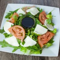 Caprese Salad · Fresh mozzarella, mixed green, tomatoes, basil and balsamic reduction.