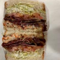 (S9) Turkey Club · Cracked pepper mill turkey, bacon, lettuce, tomato and mayo.