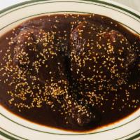 Mole Poblano · Chicken covered in mole sauce. Served with rice, beans and tortillas. 