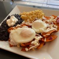 Chilaquiles Rojos · Corn tortilla chips in home-made red sauce topped with 2 poached eggs, onions, quest fresco ...