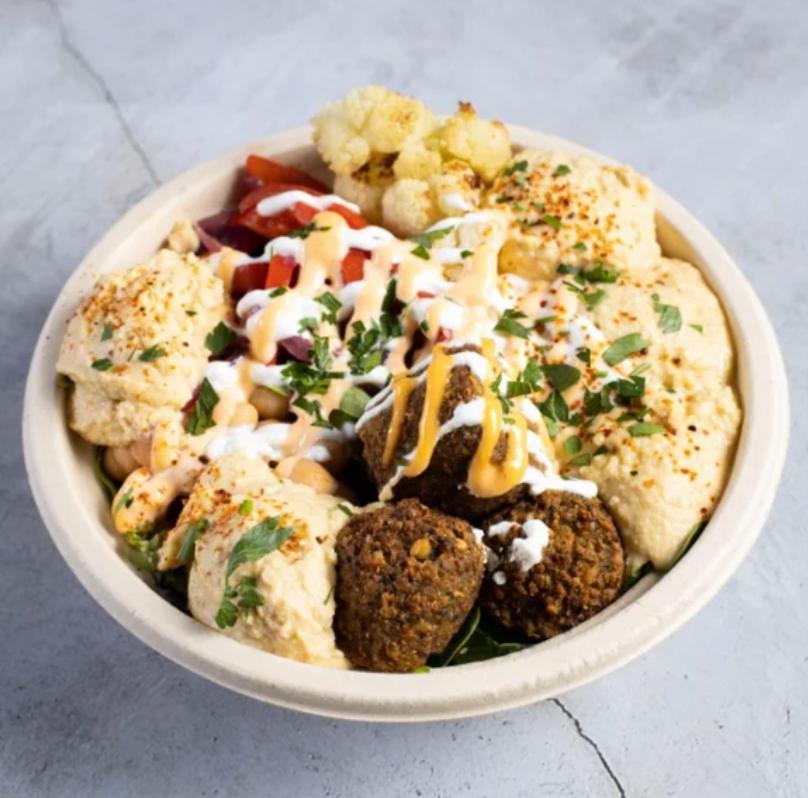 The Sinful Vegetarian Bowl · For falafel and meat lovers out there. This bowl has homemade falafel pieces made from scratch with garbanzo beans and spices using our grandmother's recipe and shawarma. It's served with house salad, hot pita bread, basmati rice, tzatziki, garlic sauce, and hot sauce. 