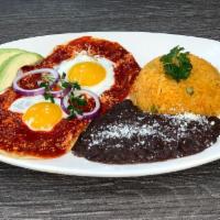 Breakfast Huevos Rancheros · 3 cripsy corn tortillas topped with tomato salsa, two sunny up eggs served with rice and bea...