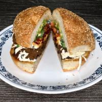 Cemitas · Sesame Roll with refried beans Oaxaca cheese, Avocado, Papalo, tomato, onions and chipotle