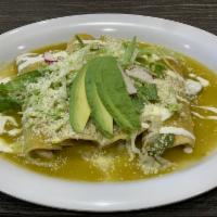 Enchiladas en Salsa Verde · 3 soft corn tortilla, topped with green salsa. Sour cream, Cotija cheese, lettuce, onions an...