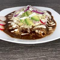 Enchilada Poblanas · 3 soft corn tortillas with mole poblano topped with sour cream, cotija cheese, lettuce, onio...