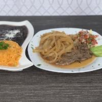 Bisctec Encebollado · Mexican style steak and onions, marinated in olive oil, various spices served with rice and ...