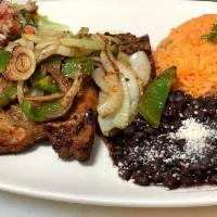 Chuleta A La Parilla · Pork chops thick cut, served with rice and beans.