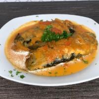Chiles Rellenos · Roasted poblano chiles stuffed with Oaxaca cheese, dipped in an egg butter and fried.