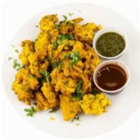 Vegetable Pakora · Fresh vegetables dipped in a special spiced batter and fried to golden perfection.