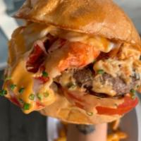 Surf 'N Turf Lobster Burger · Grilled beef patty smothered in lobster, creamy caramelized onion, cheese, and awesome sauce...