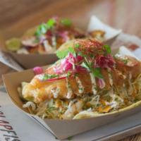 Ultimate Fish Taco · Giant two-handed fish taco, grilled or crispy, cabbage, awesome sauce, pickled onion on a fl...
