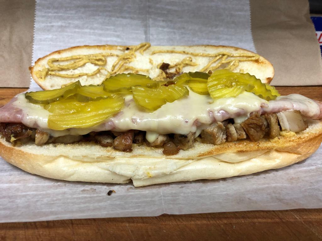 Danny's Cuban Sandwich · The Cuban Sandwich is served with roast pulled pork with ham, swiss cheese, mustard and pickle pressed on grill on a hero.