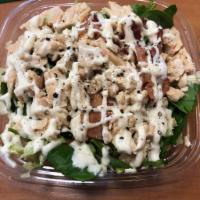 Chicken Bacon Ranch Salad · Grilled or crispy chicken, chopped romaine lettuce, tomatoes, cucumber, crispy bacon and shr...