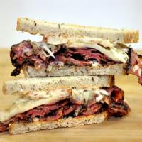 Ruben Sandwich · Choice of corn beef, pastrami or turkey served with sauerkraut, Swiss cheese and Thousand Is...