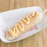 Corn on Stick · Corn on the cob, mayonnaise, butter, cotija cheese, and chili powder.
