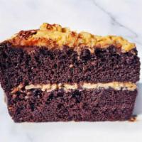 German Chocolate Cake Slice · A slice of layered chocolate cake topped with coconut-pecan frosting. Contains Nuts.