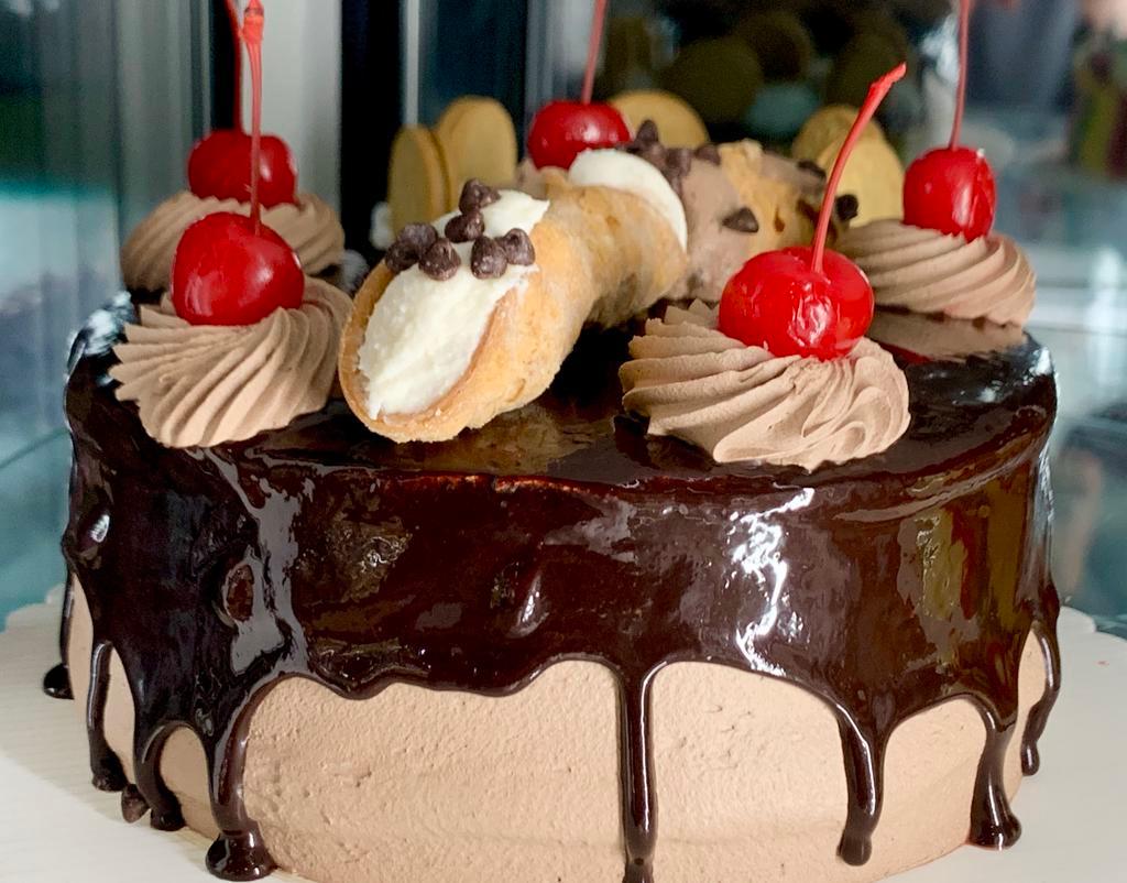 Cannoli Cream & Chocolate Mousse Cake · Cannoli cream and chocolate mousse, layered between moist chocolate sponge cake and generously covered in delicious chocolate ganache serves 10 people.