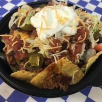 Norge Nacho Grande · Toasted Tortilla chips topped with seasoned beef, cheese, beans, pica salsa, lettuce, tomato...