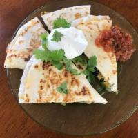Quesadilla Ranchera · Soft flour tortilla grilled and stuffed with seasoned beef or grilled chicken, cheese, pinto...