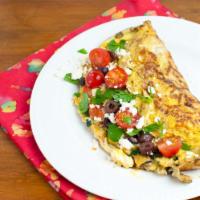 Greek Omelette Platter · An omelette severed with scrambled eggs, olives, feta and cherry tomatoes.