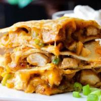 Cajun Chicken Quesadilla · Served with grilled peppers, grilled onions, cheddar cheese, Jack cheese, sour cream and sal...