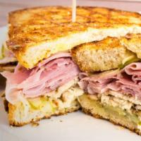 P7. The Combo Panini · Pastrami, corned beef, provolone cheese, lettuce, tomatoes, mustard and hours dressing.