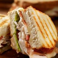 P12. Chicken Club Panini · Grilled chicken, smoked bacon, Brie cheese, plum tomatoes and house dressing.