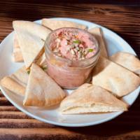 Pink Hummus  · Beetroot, citrus, red chili flakes, sunflower seeds and baked pita chips. 