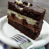 Tuxedo Chocolate Cake  · Moist chocolate cake filled with rich chocolate mousse and sweet white chocolate filling & b...