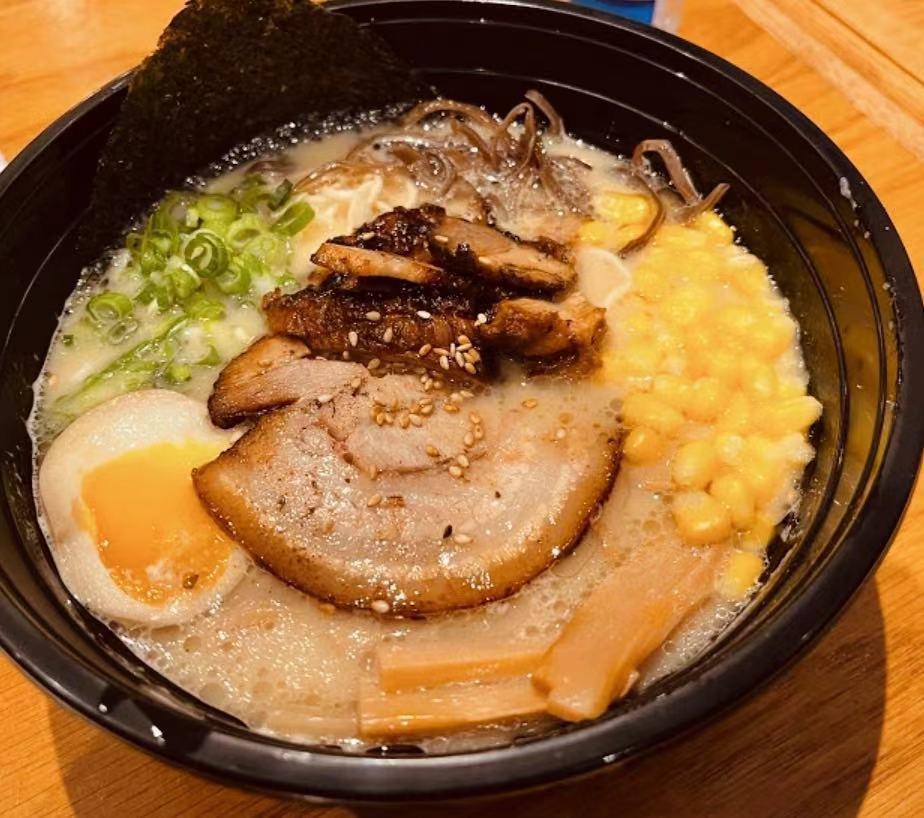 Miso Ramen  · Miso soup combined with chicken and pork broth with 12 vegetables blend in miso, fermented for a moth. Topped with 2 sliced grilled chashu, scallion, bamboo shoot, woodear mushroom, organic sweet corn, 1/2 soft boiled egg and seaweed.