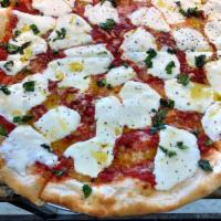 Margherita Pizza · Marinara sauce, fresh mozzarella and basil with a drizzle of extra virgin olive oil.