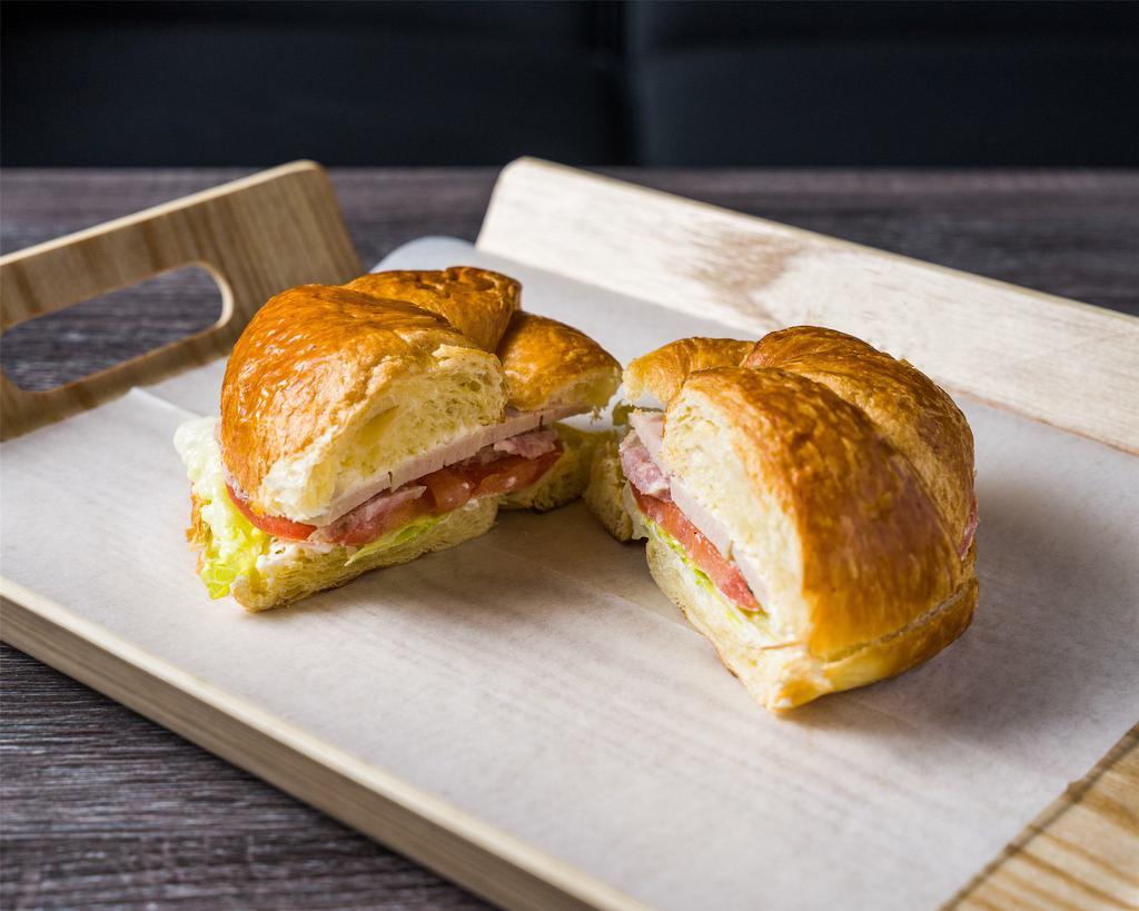 Ideal (ham and Egg) Croissant Sandwich · House special 2 hams with American cheese or Swiss cheese with lettuce, tomatoes, butter and mayonnaise.