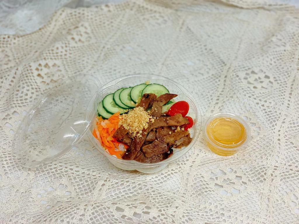 Marinated Grilled Pork Bowl · Item contains: rice noodle, lettuce, tomatoe, cucumber, marinated carrot and white radish, grinded peanuts with homemade sauce on the side.