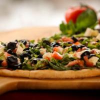Arugula Salad Pizza · Arugula, diced tomato, olive, fresh Mozzarella, and diced avocado.