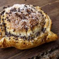 Pastelito · Sweet empanada with fruit filling, coconut, and chocolate syrup, served piping hot in our sc...