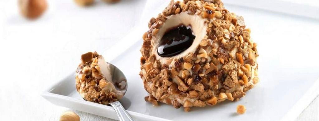 Hazelnut Truffle · Hazelnuts semifreddo ice cream with a liquid chocolate core, coated with praline hazelnuts and crushed meringue.