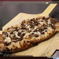 Roman Philly Pizza · Balsamic onions, shredded mozzarella, and thinly sliced rib-eye.