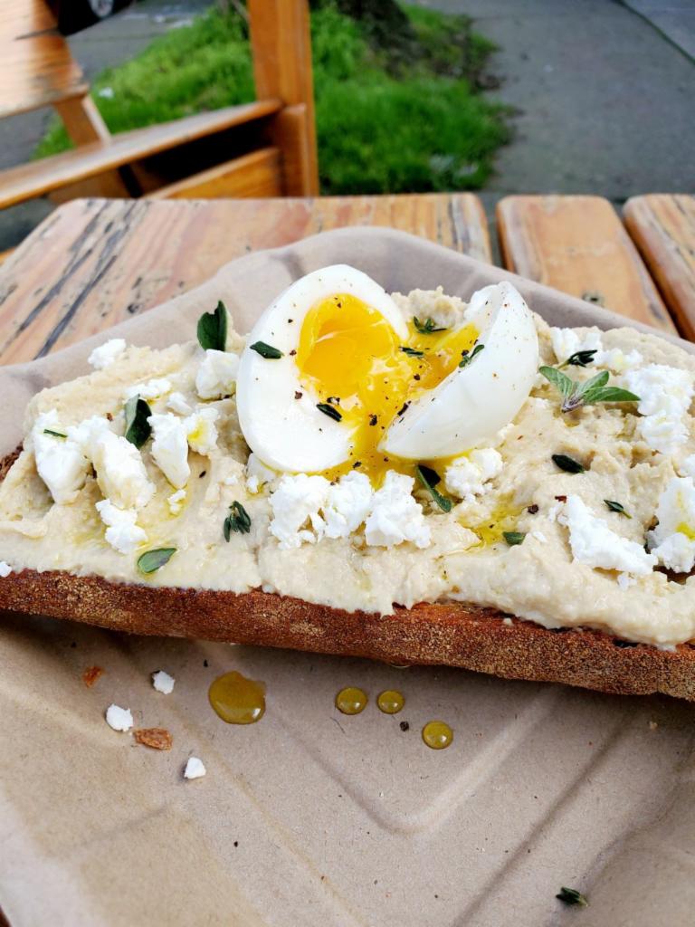 Hummus Toast · Made in-house hummus spread, feta cheese, thyme, oregano, olive oil, on a fresh sourdough bread