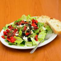Tuscan Salad · Chopped romaine, feta cheese, roasted red peppers and black olives, drizzled with basil pesto.
