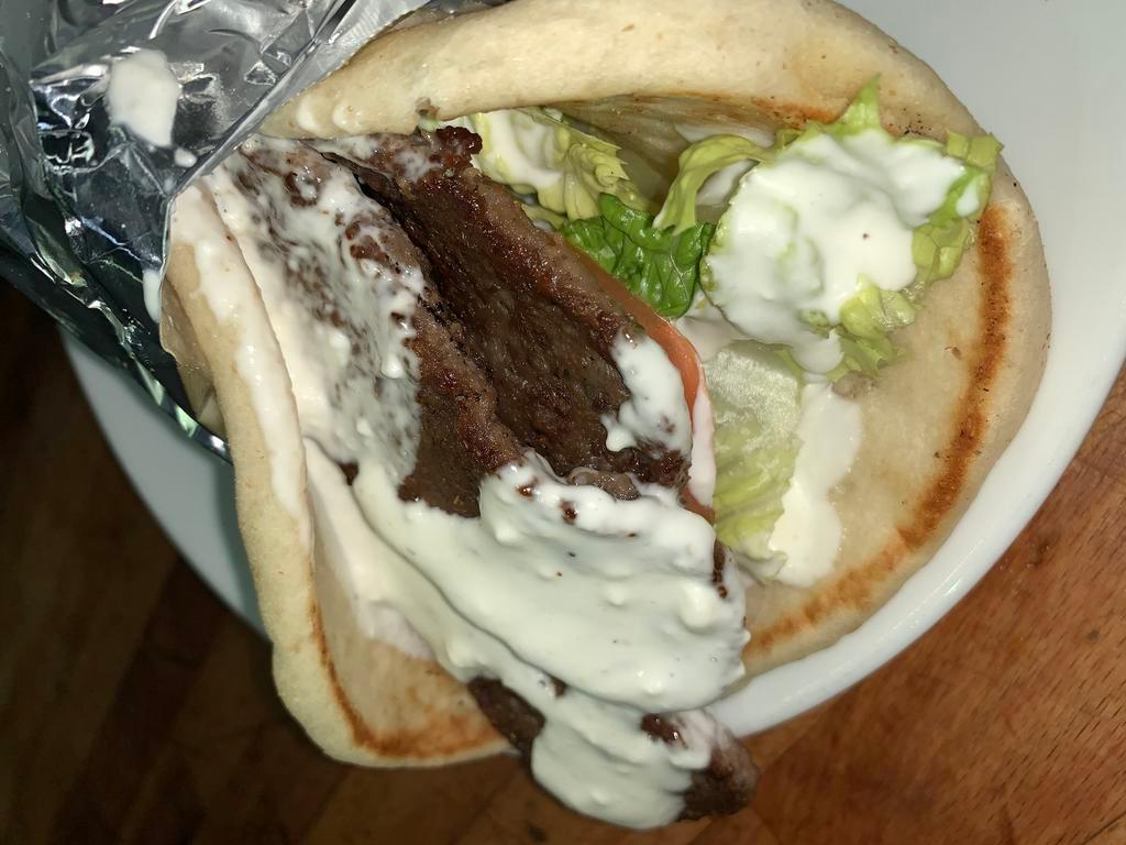 Gyro Sandwich · Served with white sauce, lettuce, tomato and onions.