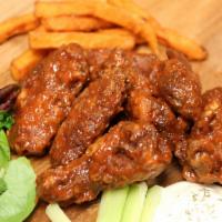 Mild Smilin Wings · Hand tossed in a traditional blend of warm, savory Buffalo spices and wing sauce. Served wit...