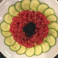 Tuna Tartare · Yellowfin tuna, tsuke joyu, sesame, wasabi infused guacamole, tobiko, cucumber. Gluten-free.