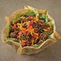 Taco Salad · Crisp lettuce in a fried tortilla shell, topped with taco seasoned ground beef, tomato, shre...
