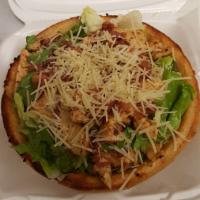 Chicken Caesar  · Freshly baked bread bowl filled with crisp salad greens topped with seasoned grilled chicken...